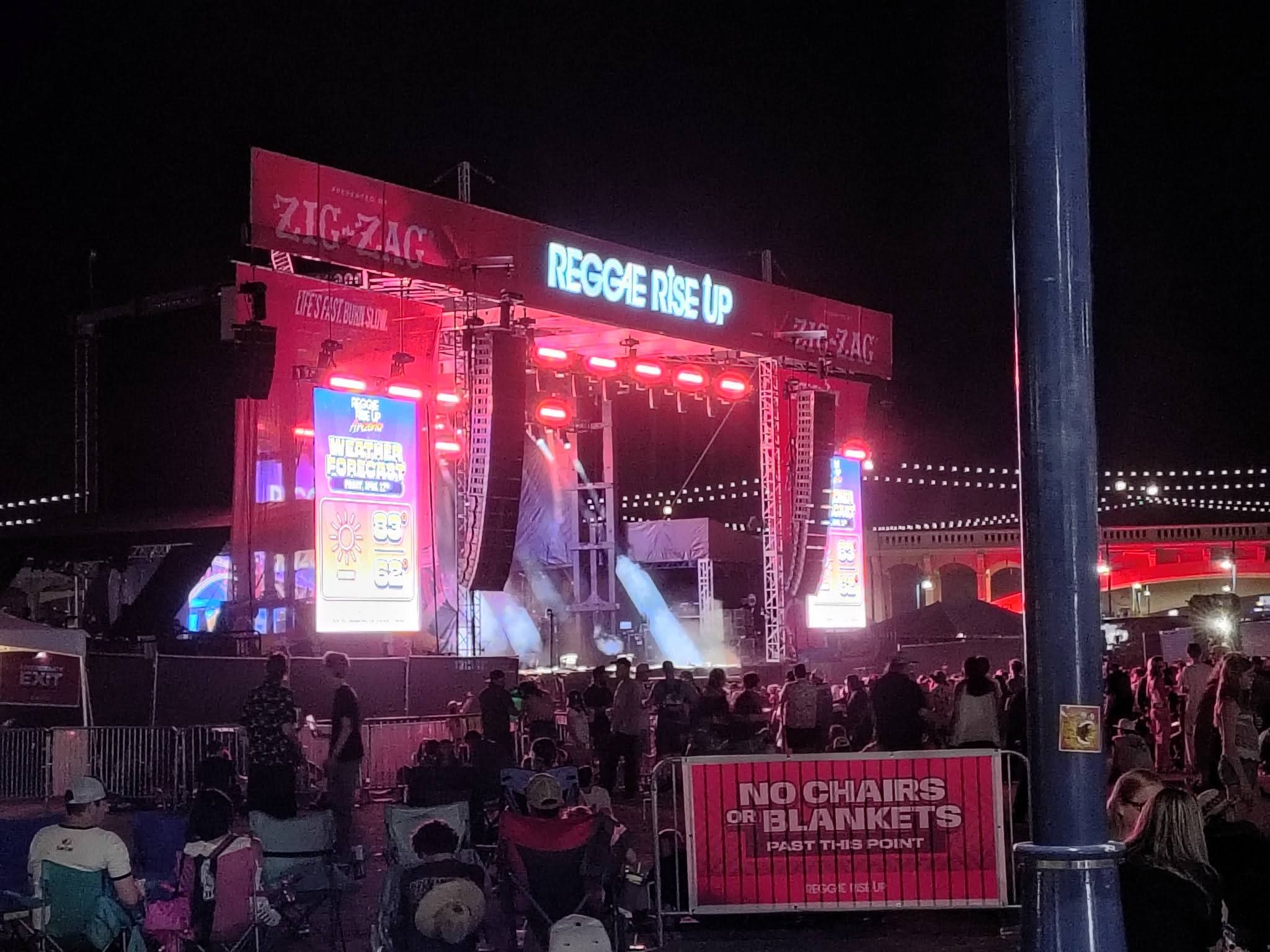 Reggie Rise Up festival main stage at night with live crowd and ZIG-ZAG sponsor branding
