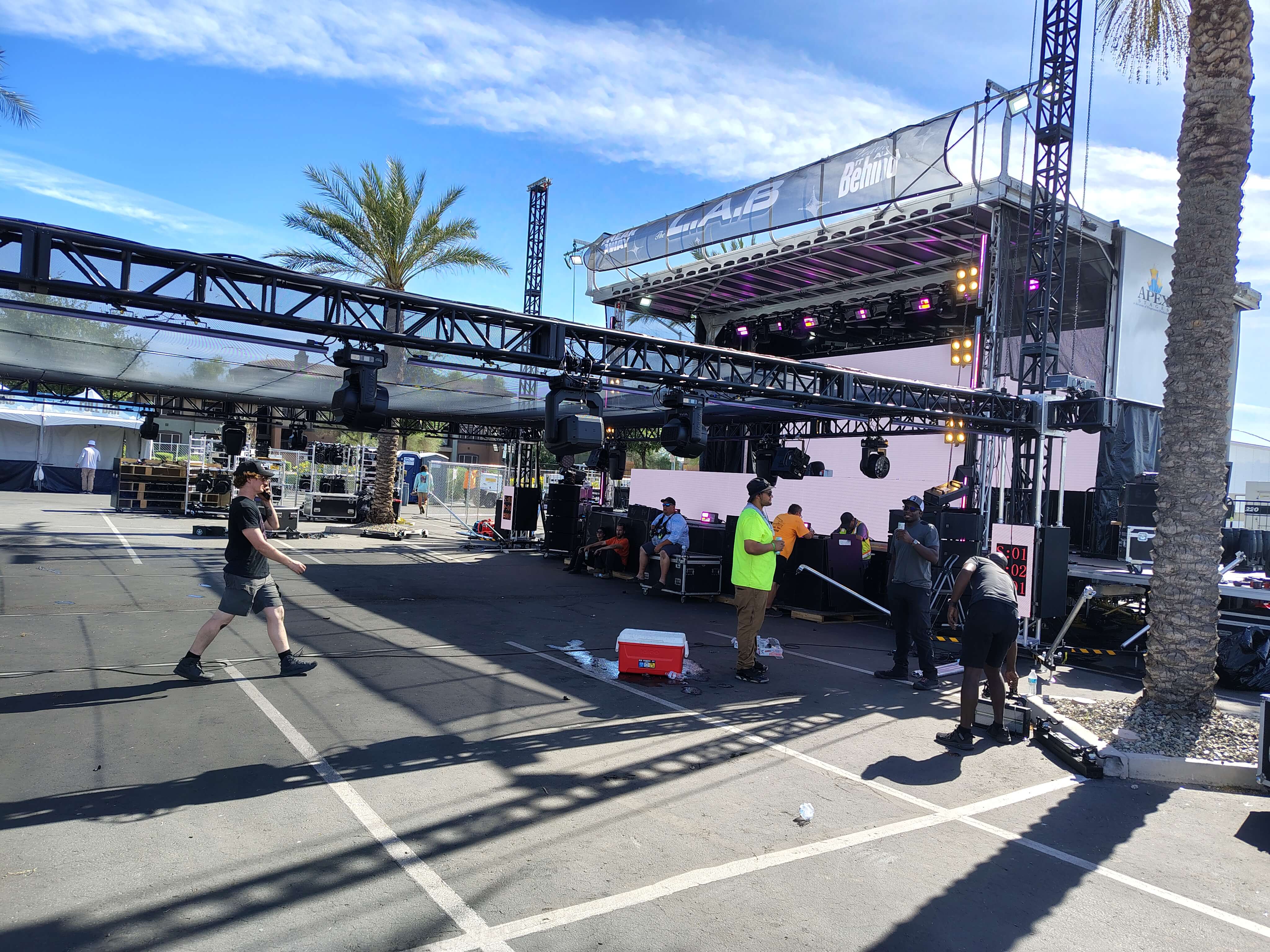 Production crew and lighting truss around a mobile stage during Breakaway Mesa 2026 outdoor setup