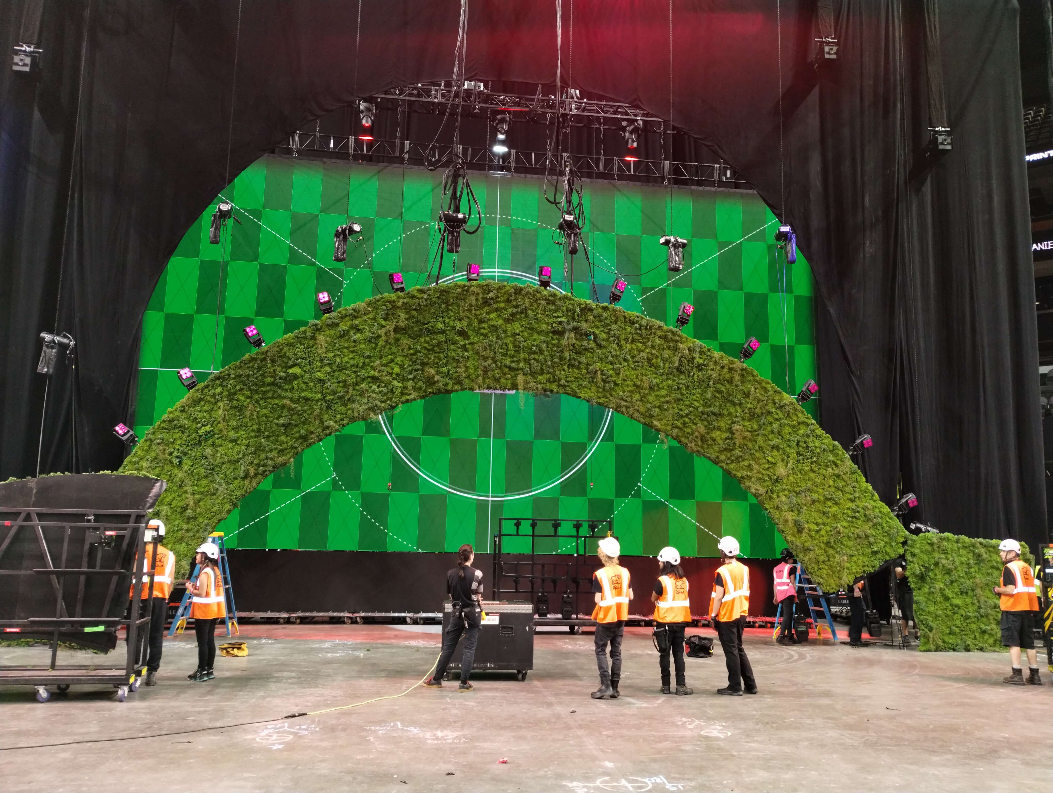 Kacey Musgraves Deeper Well World Tour scenic green hill set elements during arena load-in