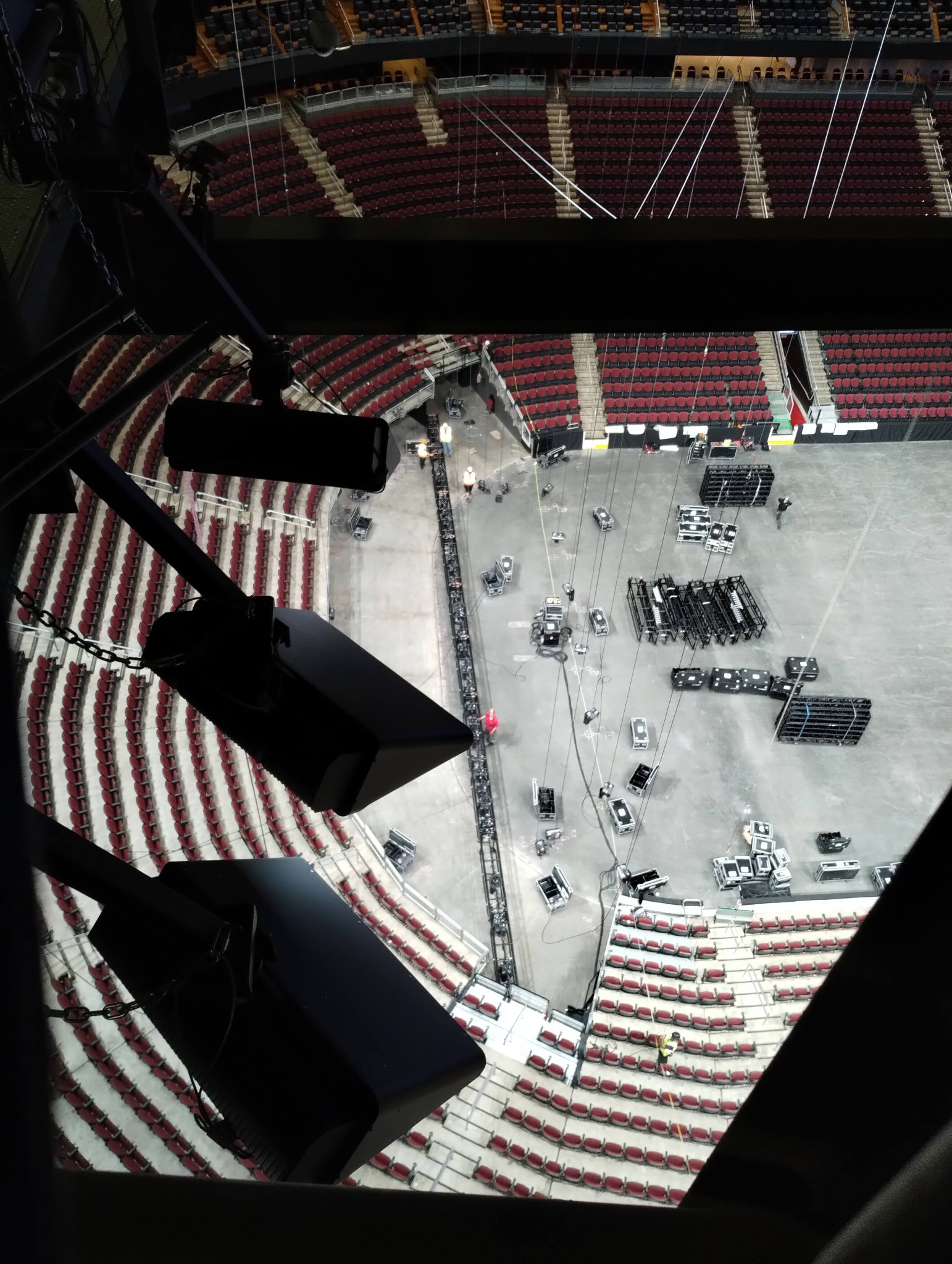 Bird's-eye view looking down from a followspot position high above an arena floor during production load-in